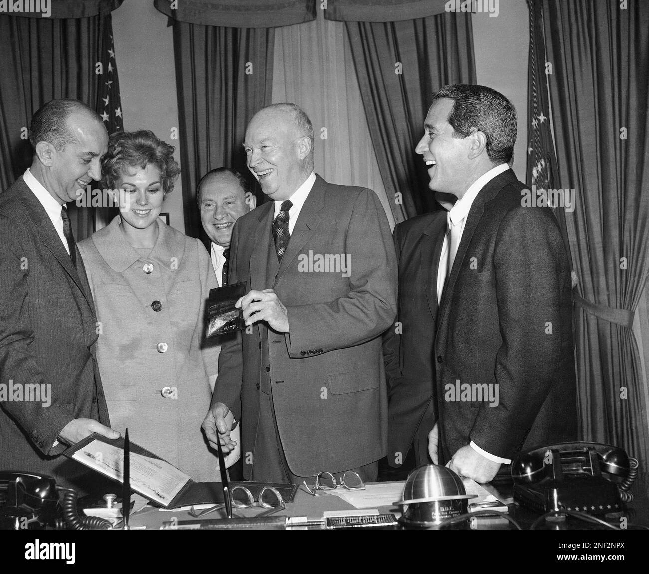 President Dwight Eisenhower holds a membership card making him a