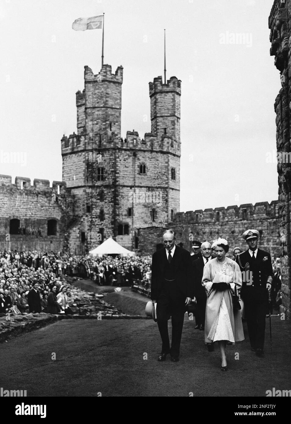 Queen Elizabeth II walks on the grounds of Caernarfon Castle in Wales, July 10, 1953 as the