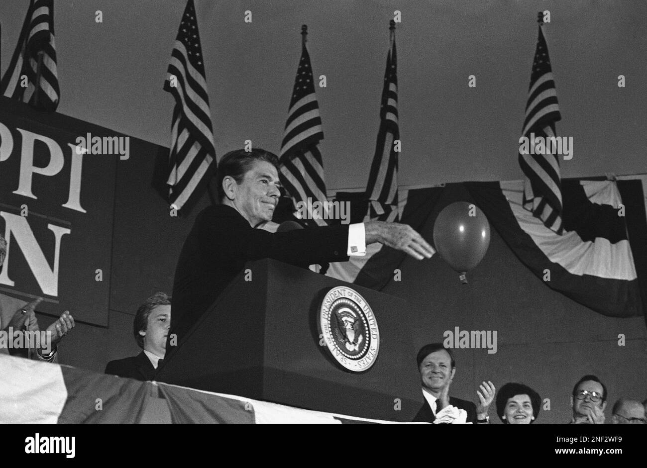 U.S. President Ronald Reagan swats away a balloon during the closing  moments of a campaign rally in evening, Monday, Oct. 1, 1984 in Gulfport,  Miss. Reagan, on a campaign swing through Mississippi,