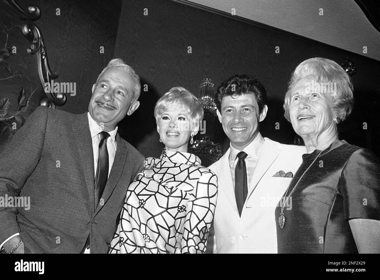 Eddie Fisher and Connie Stevens during their wedding engagement party at the Fontainebleau Hotel in Miami Beach, Florida, Feb. 6, 1967. Man at left is Ben Novack. Woman at right is Jennie Grossinger. (AP Photo/Toby Massey) Stock Photo