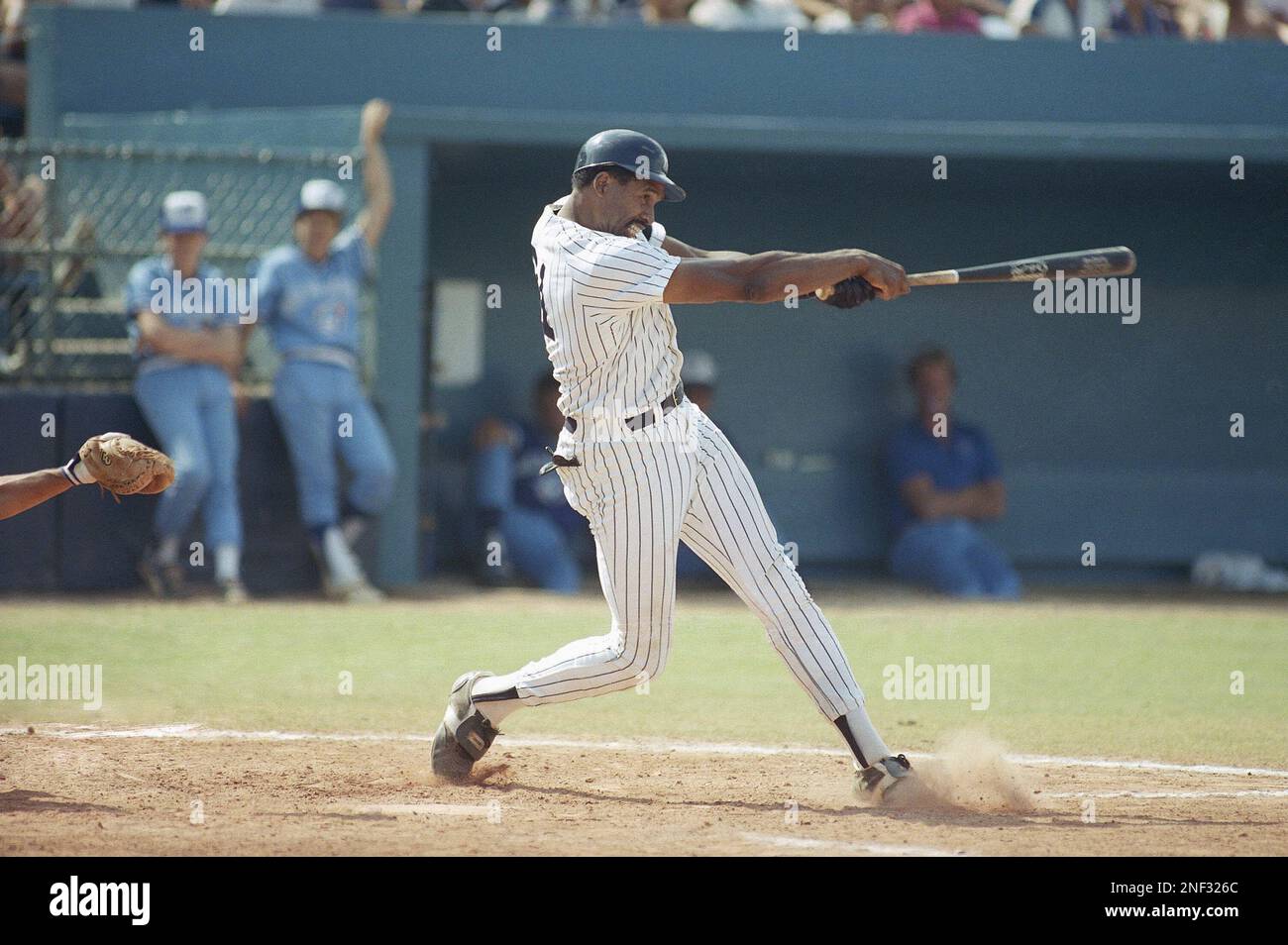 New York Yankees outfielder Dave Winfield swings hard connecting with a  pitch by Toronto Blue Jays Jim Clancy for a grand slam homer in the fifth  inning of spring training game, Sunday