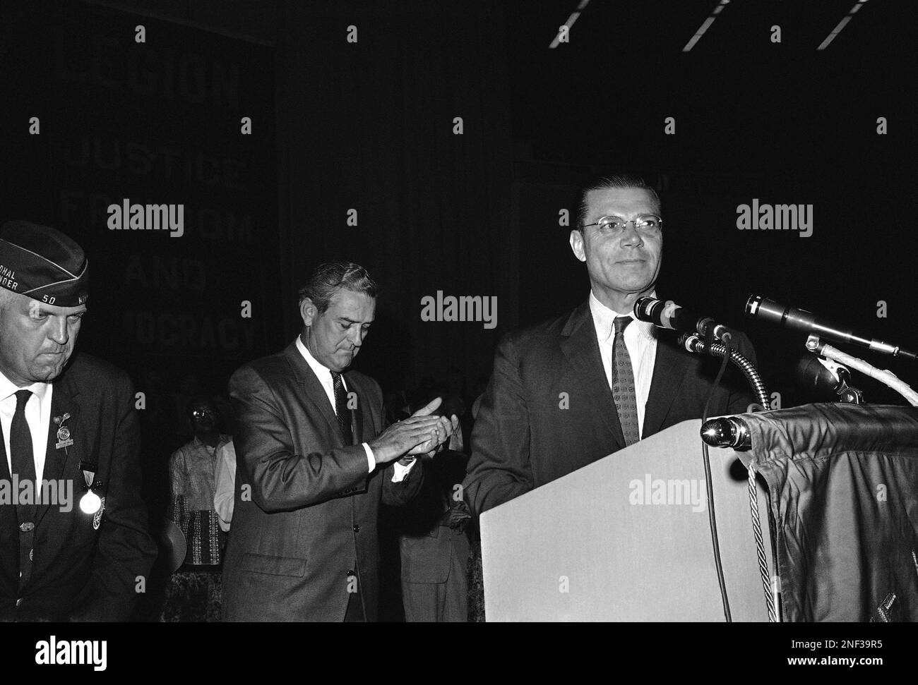 Texas Gov. John Connally, left, applauds after he introduced Robert