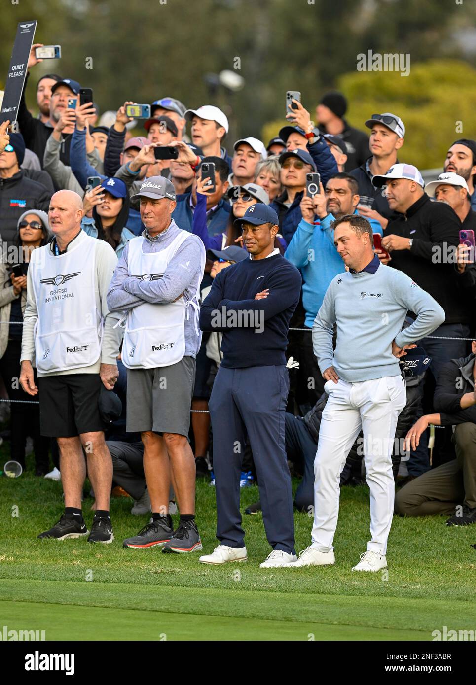 Pacific Palisades, California, USA. 16th Feb, 2023. Tiger Woods, Justin Thomas and their caddies wait for Rory Mclloryto putt on the 18th green during the first round the Genesis Invitational at the Riviera Country Club on February 16, 2023. Tiger birded the last three holes to finish the round two under par. (Credit Image: © Mark Edward Harris/ZUMA Press Wire) EDITORIAL USAGE ONLY! Not for Commercial USAGE! Stock Photo