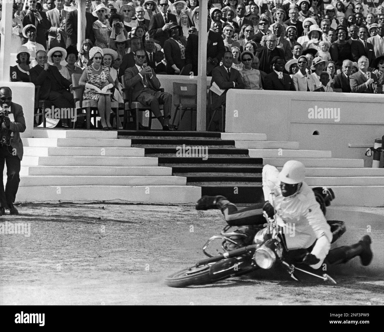 Nassau police rider, Lockhart, takes a fall in front of Queen(02)