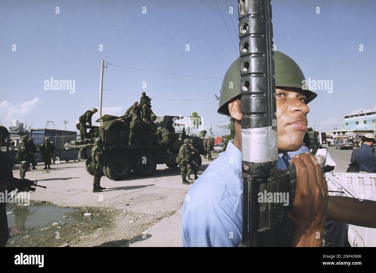 A Haitian police officer stands guard outside the port in Portau