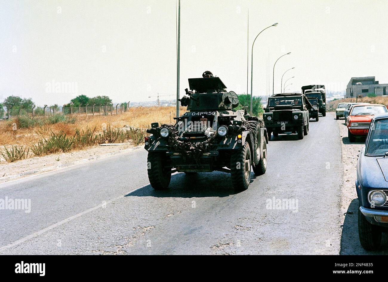 British Troops, ferret cars, and Saracen Light Tanks are shown arriving