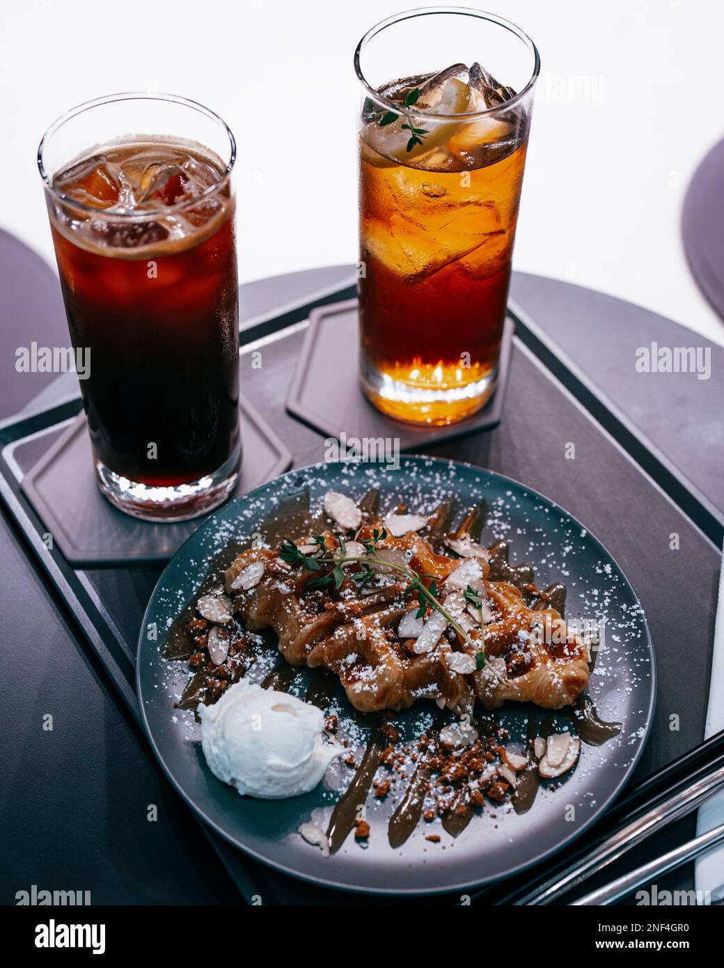 Iced Coffee, Iced tea, and delicious waffles with ice cream on a tray ready to be served Stock