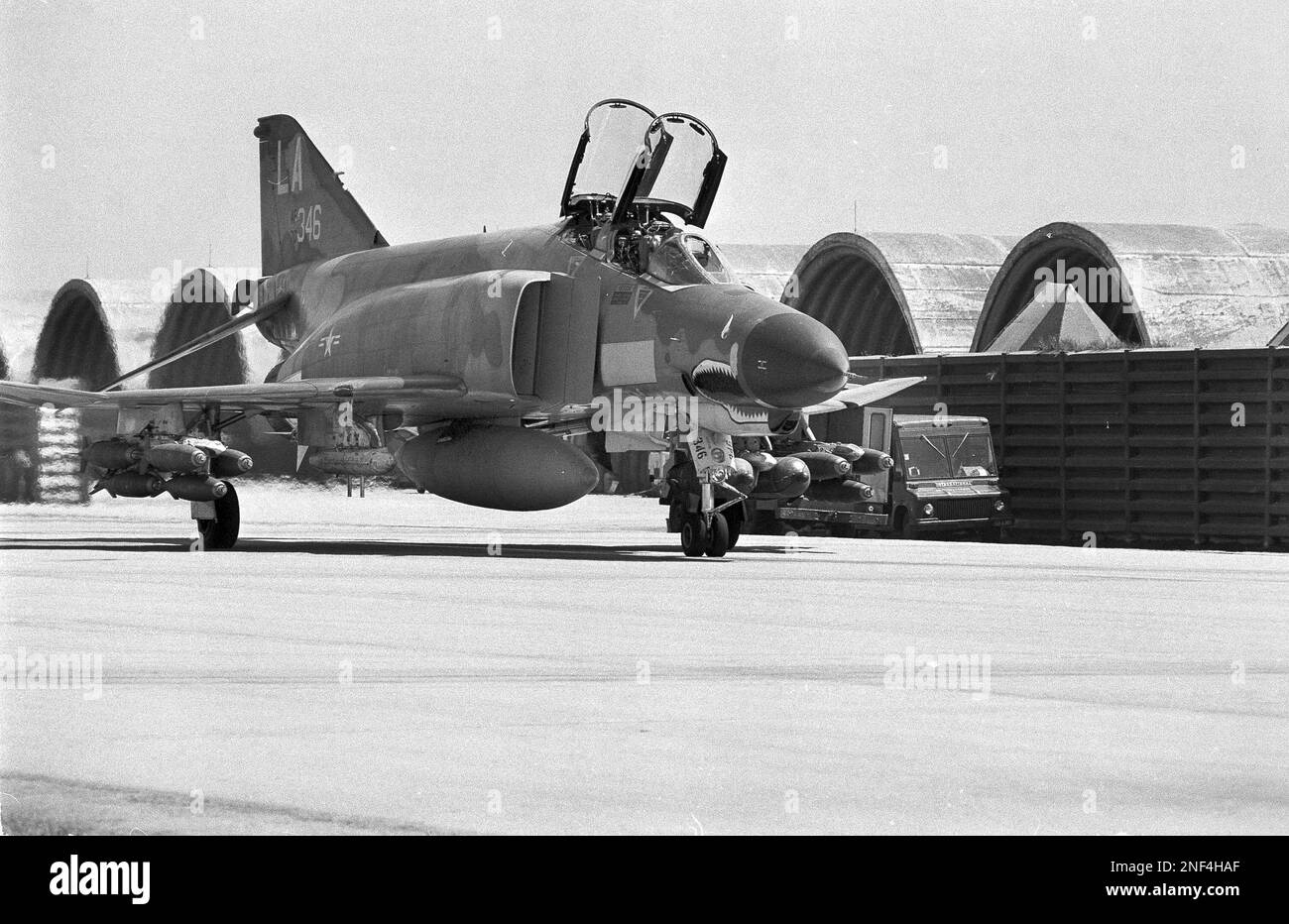 A U.S. Air Force F-4 Phantom jet, loaded with bombs, prepares to take ...