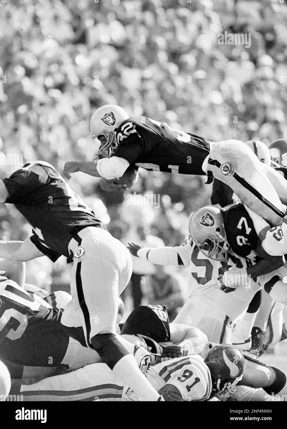 Los Angeles Raiders running back Marcus Allen (32) goes up and