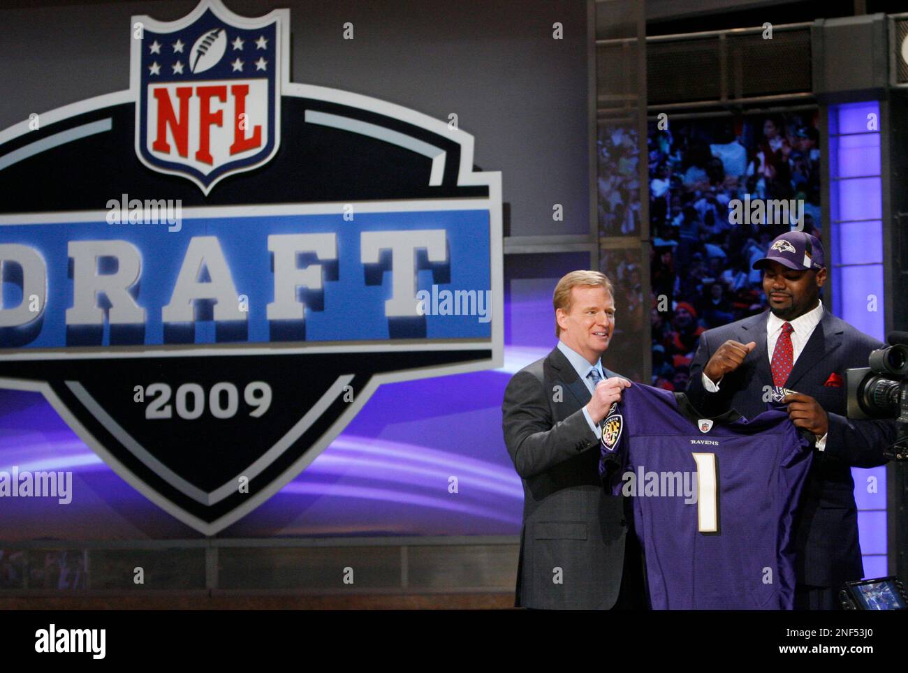 Michael Oher, a tackle from Mississippi, holds up a jersey after