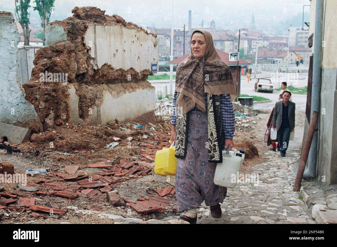Sarajevo Residents Walk Up Through The Old City With Water Containers 
