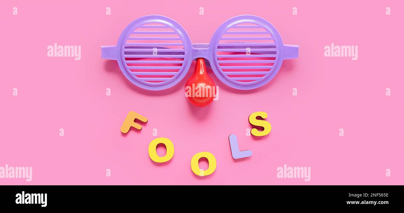 Funny disguise and word FOOLS on pink background. April Fools' Day ...