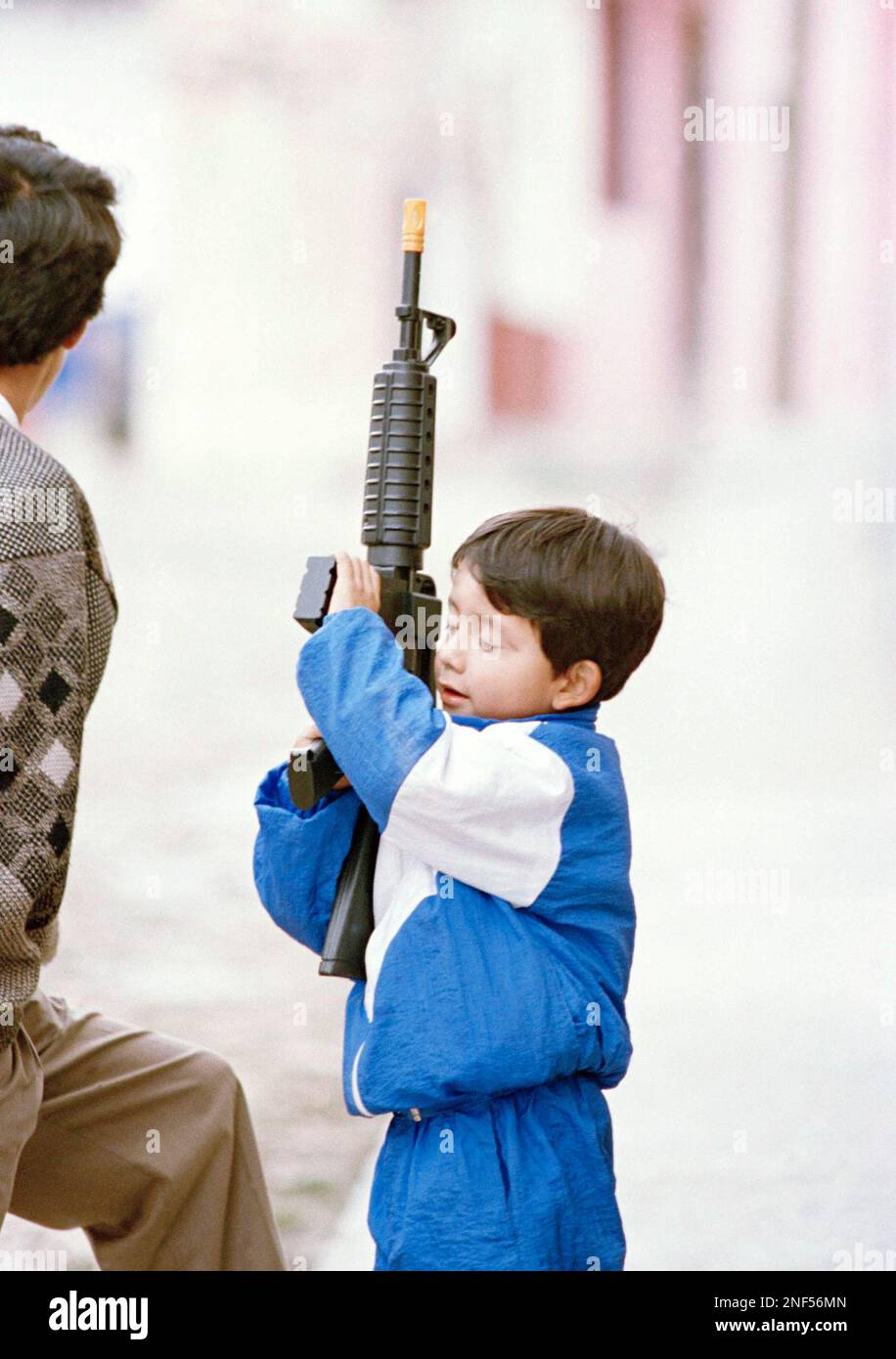 A youngster on the streets of San Cristobal de las Casas, Mexico plays