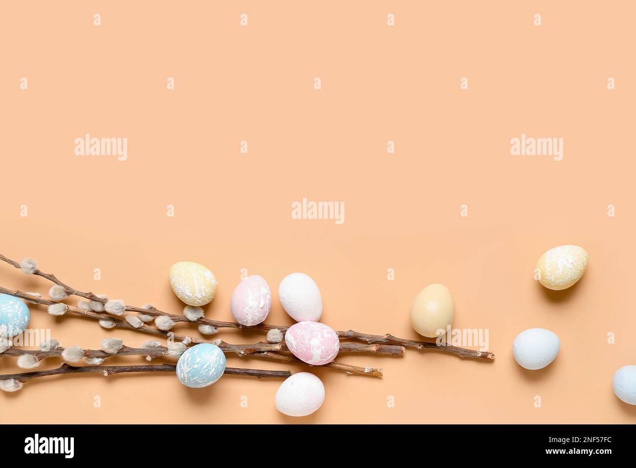 Composition with beautiful Easter eggs and willow branches on color ...