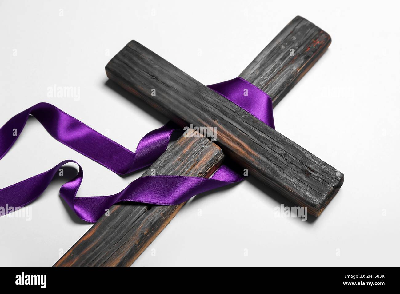 Wooden cross with purple ribbon on light background. Good Friday concept Stock Photo Alamy