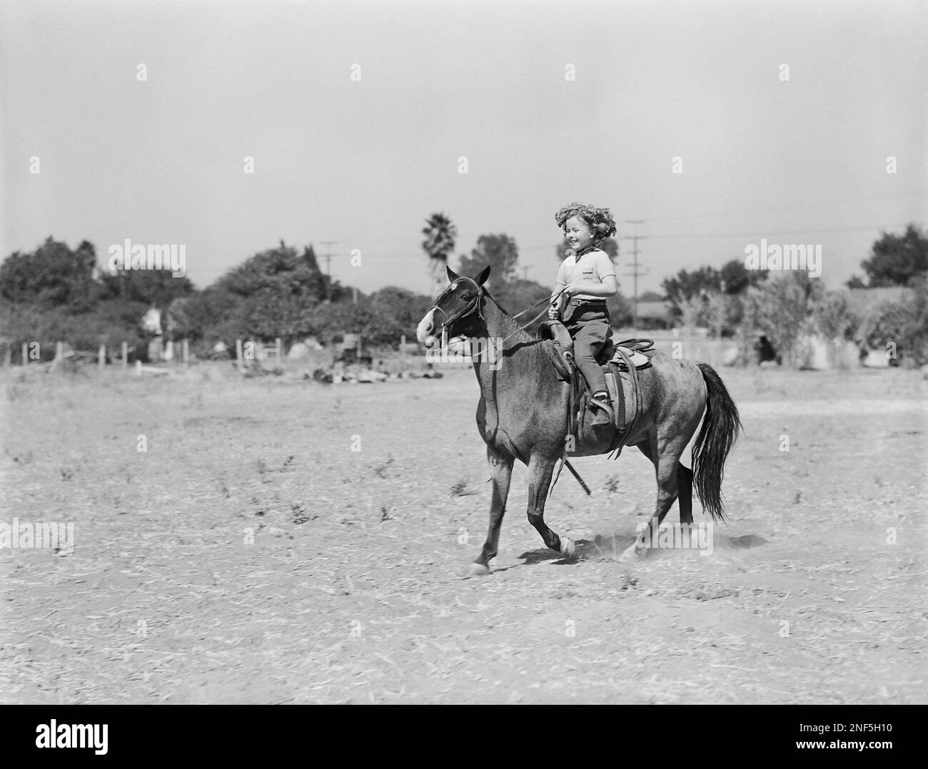 Shirley Temple, child star of the screen, tries out her newest pony ...