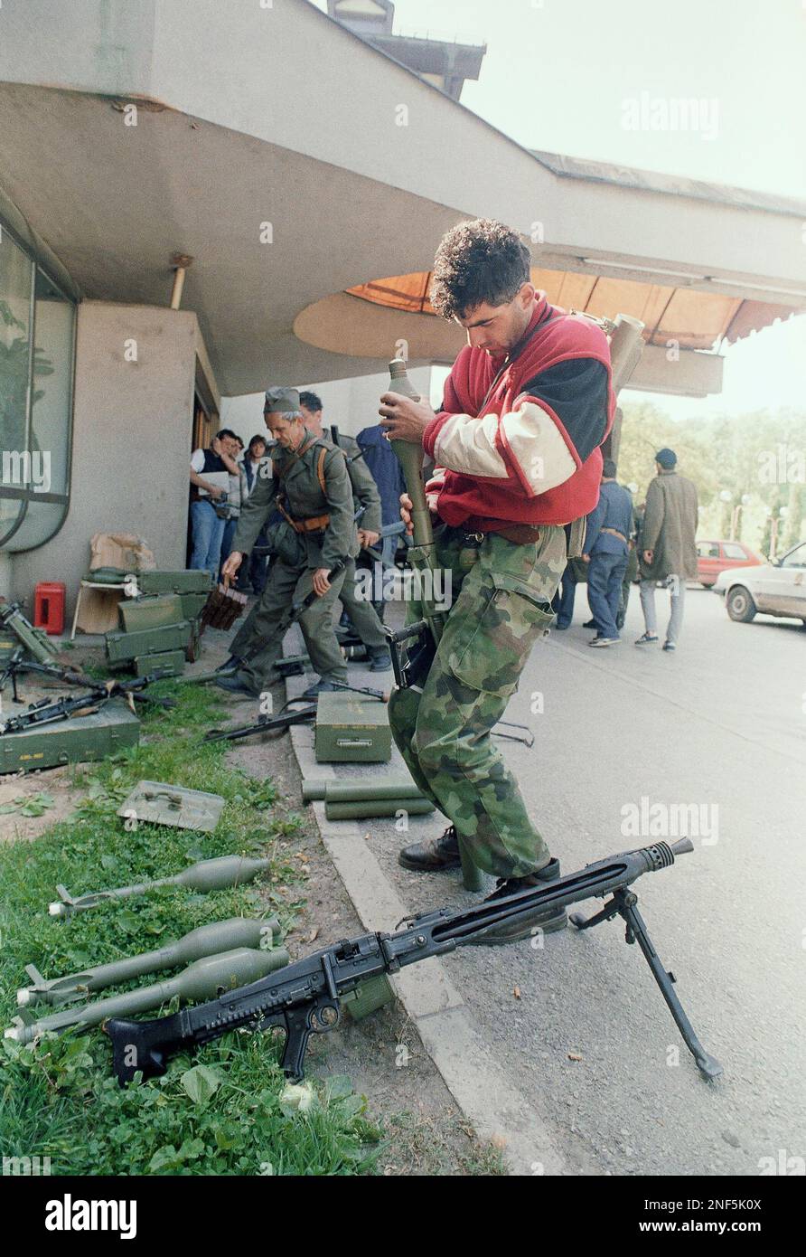 A Serbian irregular fighter loads his rocket propelled grenade launcher ...