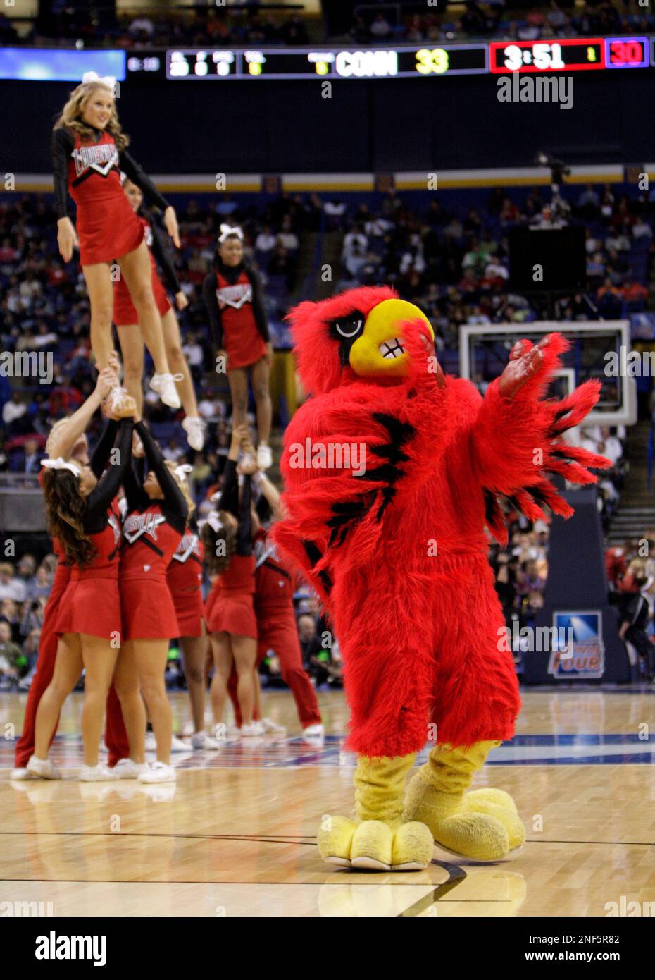 The Louisville mascot and cheerleaders entertain in the first half of