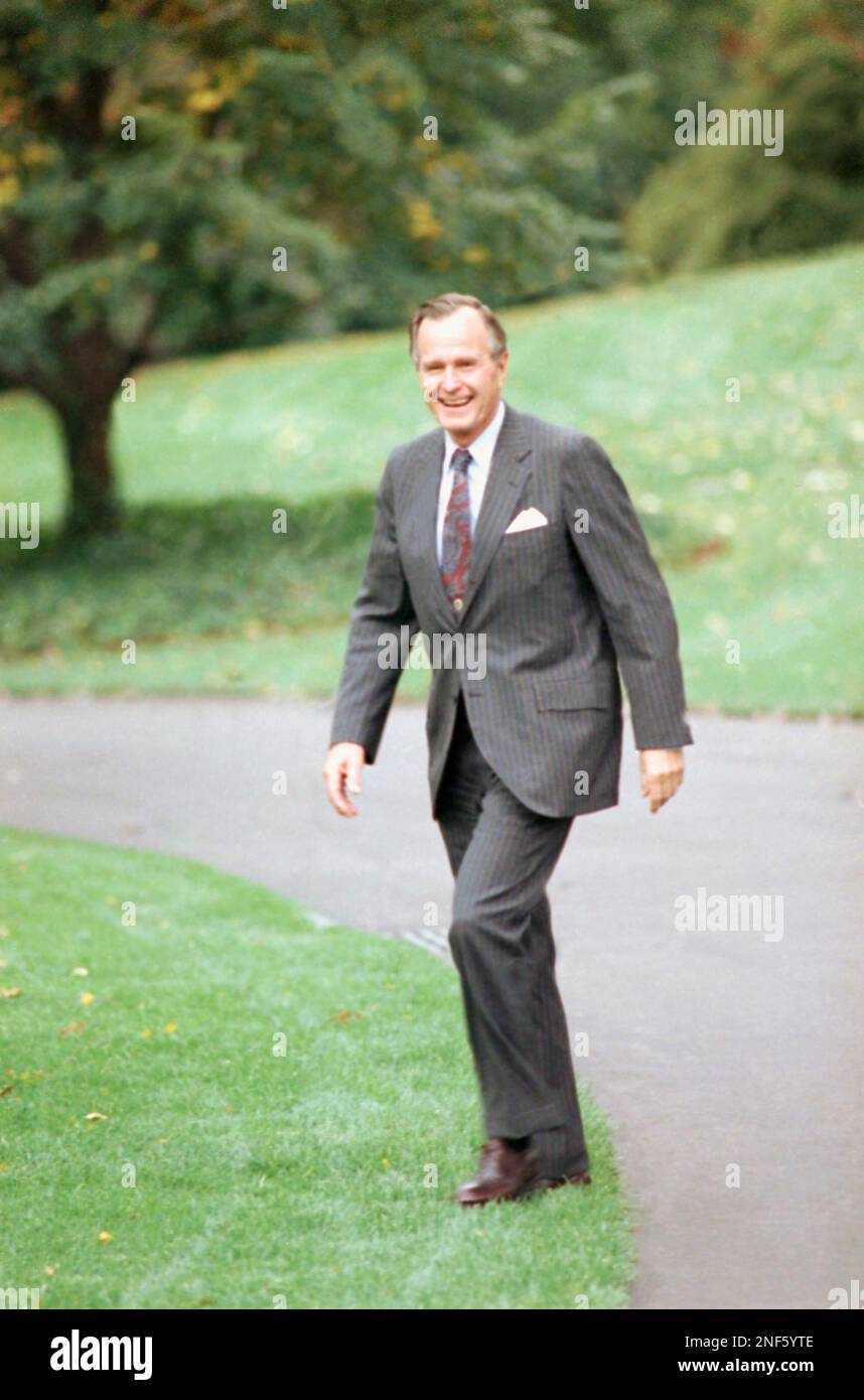 U.S. President George H. Bush gives a double thumbs-up when asked about ...