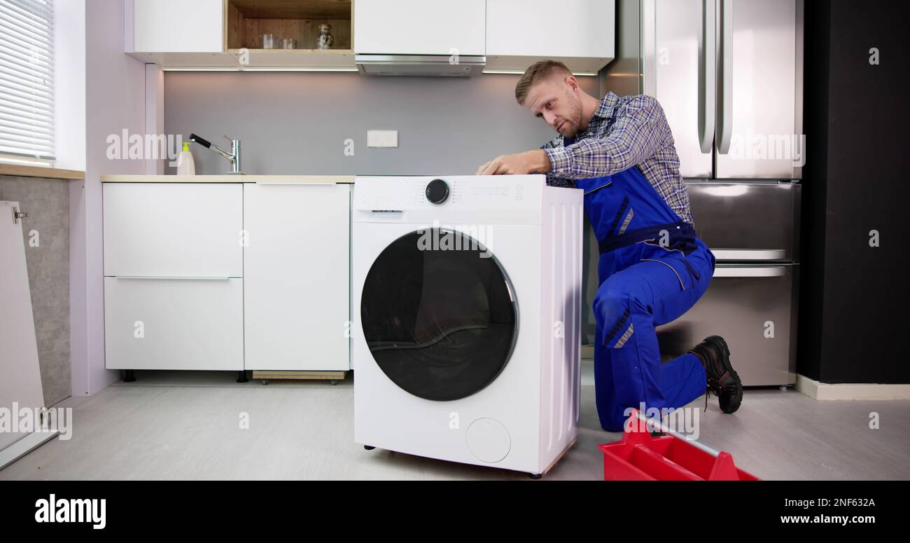 Washing Machine Repair Problem. Man Fixing Appliance Stock Photo Alamy