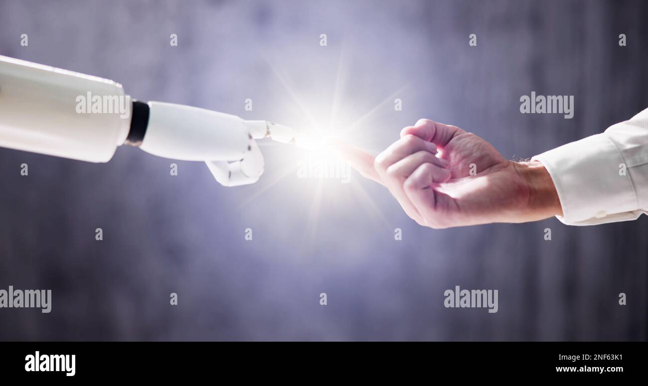 Robot Touching Human Finger Against Gray Background Stock Photo