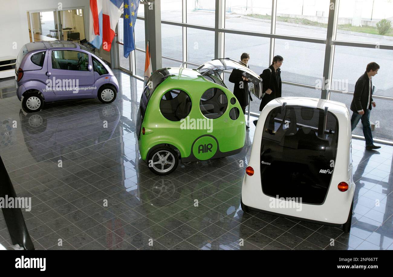 Cars powered by compressed air, left, a "Miniflow Air" and "AirPod" of MDI  (Motor Development International), are seen at the MDI head offiice in  Carros, near Nice, southern France, Friday, Jan. 30,