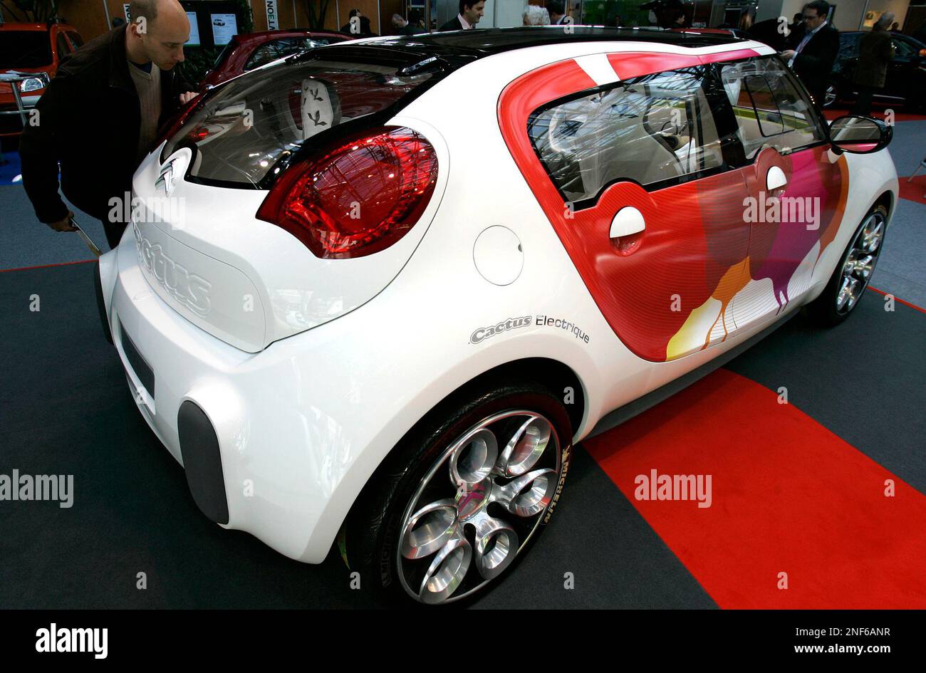 A visitor looks at a prototype of Cactus, an all-electric concept car  manufactured by Citroen and displayed in the EVER Monaco 2009, a trade show  dedicated to Ecological Vehicles and Renewable Energies,