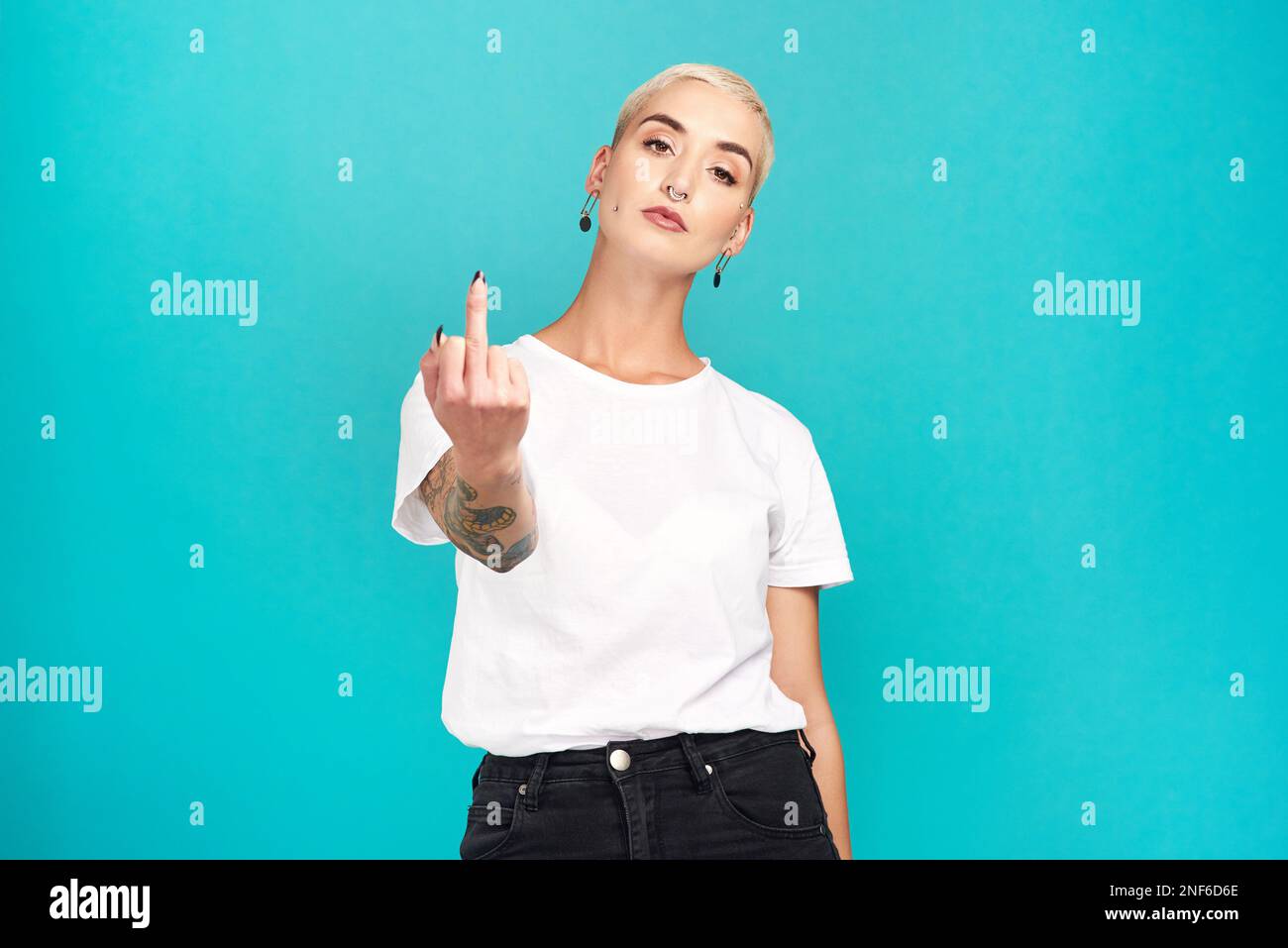 Does it look like I care. Studio shot of a young woman showing her ...