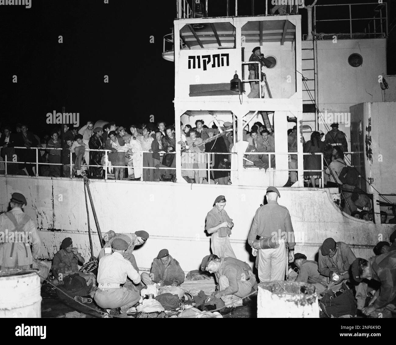 View of the side of the ship showing the crowded rails and name of the
