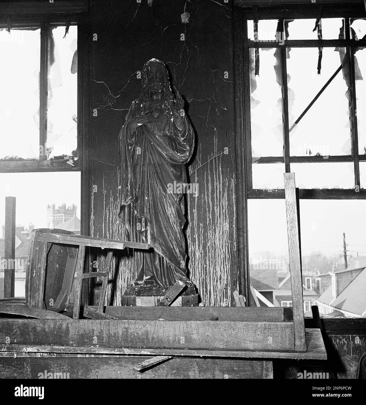 The smoke scarred statue of Jesus stands in the second floor hallway of the debris littered Our Lady of Angels grade school in Chicago, on Dec. 2, 1958 after fire and explosion claimed 90 lives December 1. (AP Photo/HKH) Stock Photo