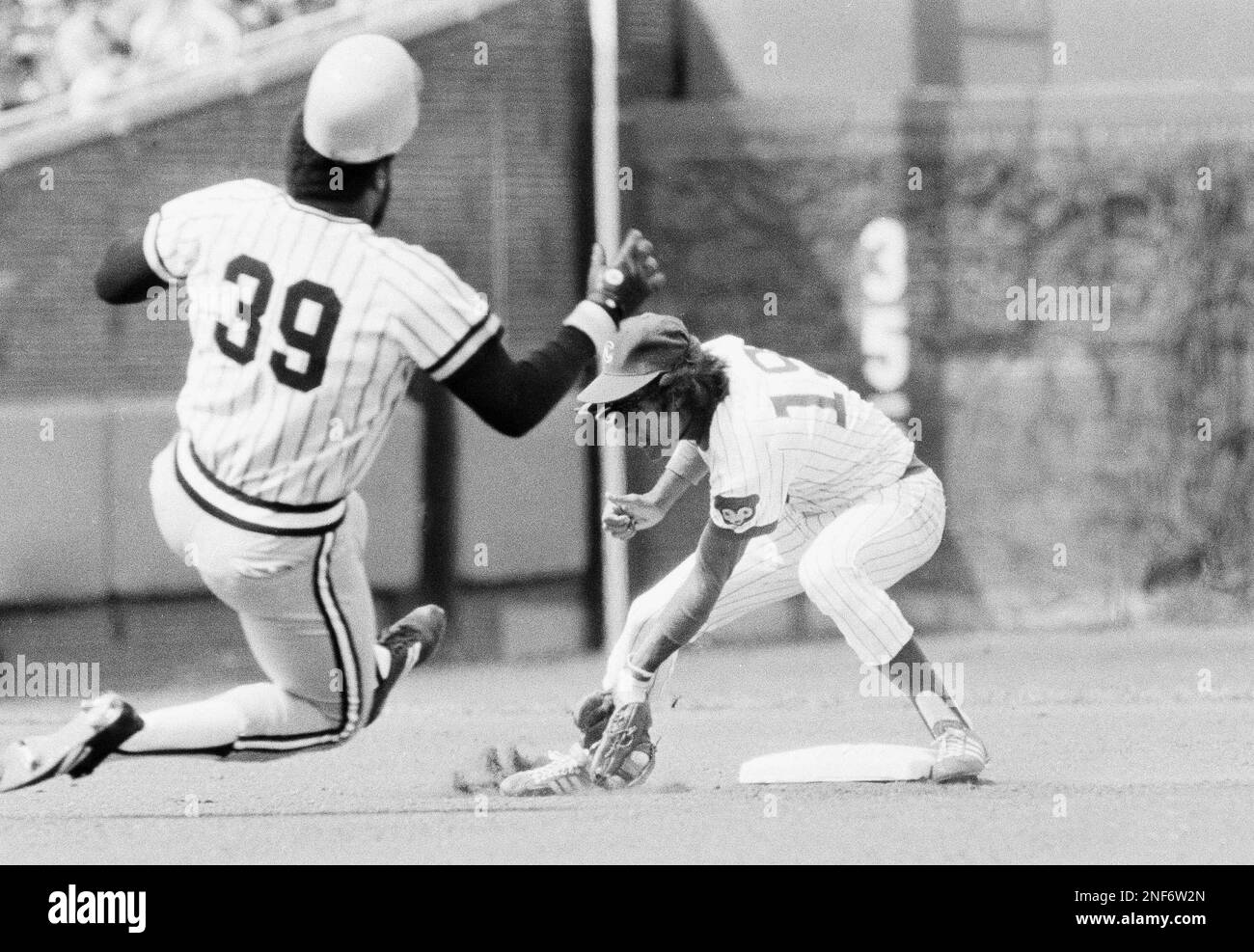 Pittsburgh Pirates' Dave Parker (39) starts slide into second as