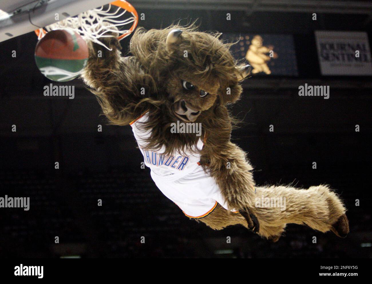 The Oklahoma City Thunder mascot dunks the ball during a stoppage in play  against the Houston Rockets at Chesapeake Energy Arena.