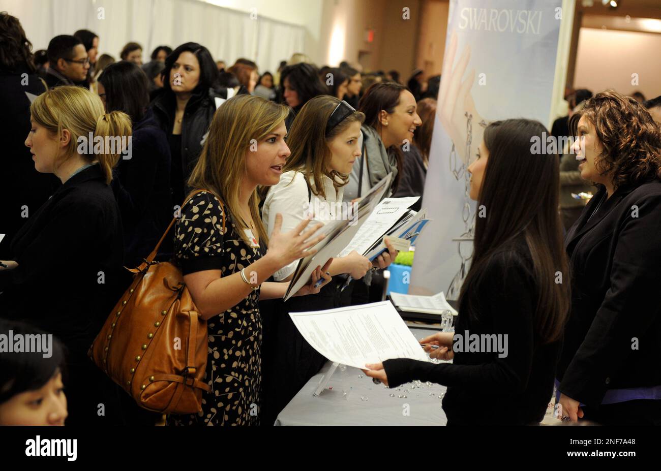 Alison Ungerleider, center, meets with a representative from Swarovski at  the WWD Fashion Career Expo, Friday, Feb. 20, 2009, in New York. People  looking for jobs in the fashion industry met with