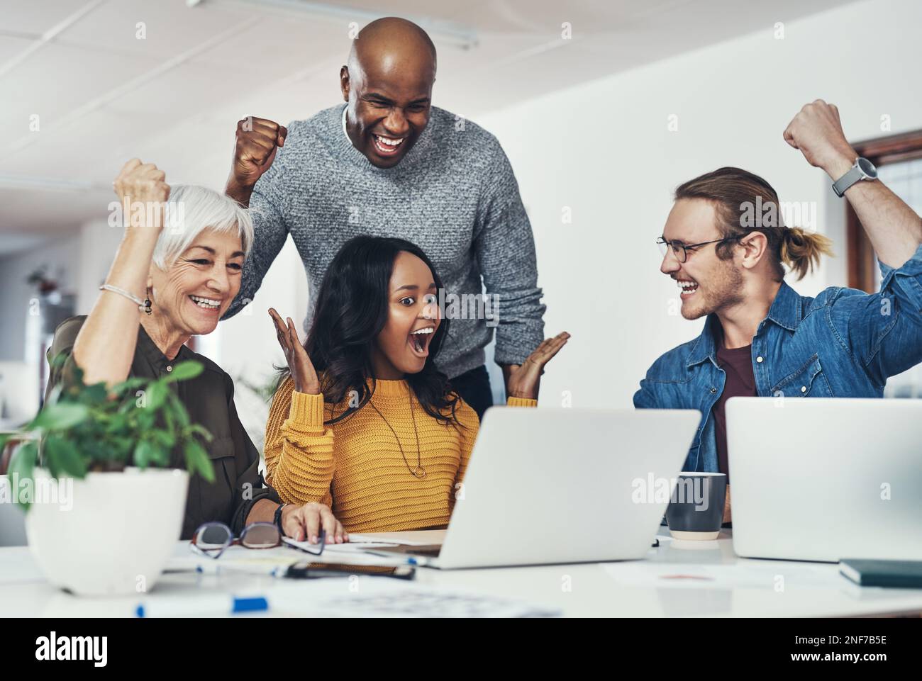 Our hard work is paying off. a group of cheerful businesspeople looking ...