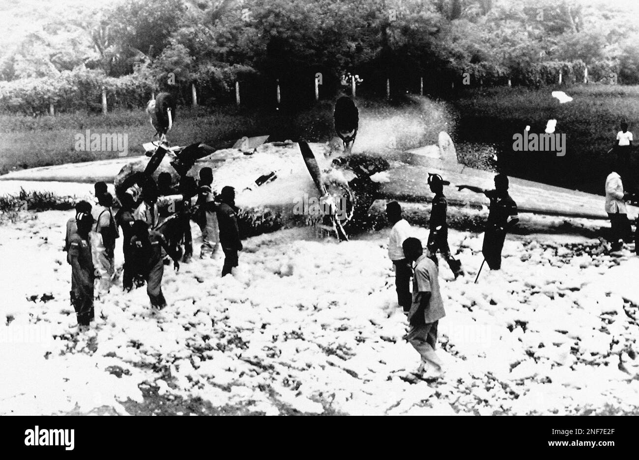 Manila Airport firemen spray foam on a C45 twinengine cargo plane