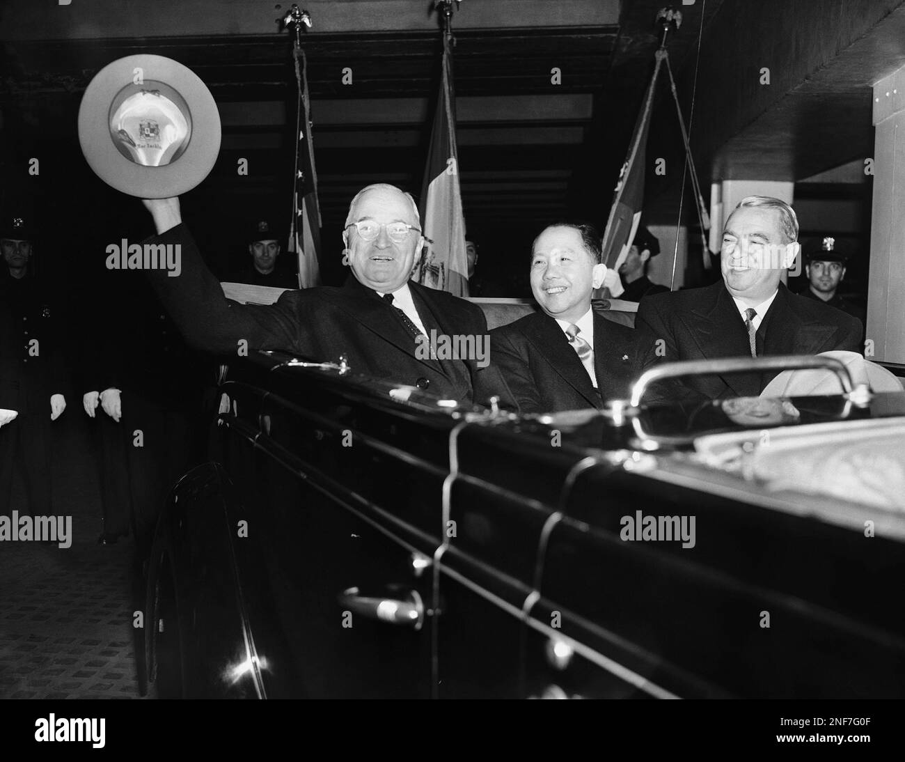 President Harry S. Truman waves from a car as he leaves Pennsylvania ...