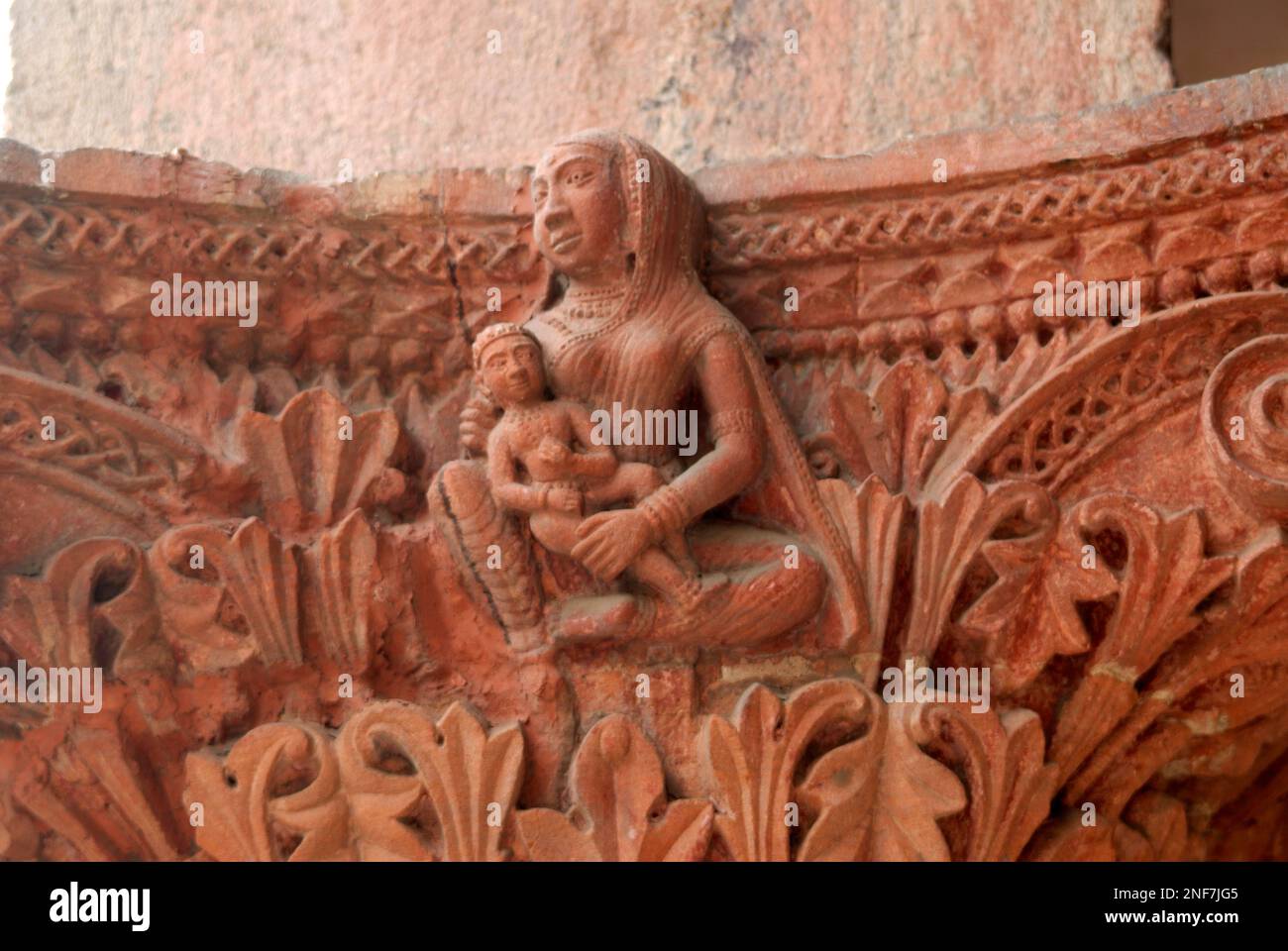 Relief art work of women with a child on decorative piller of old