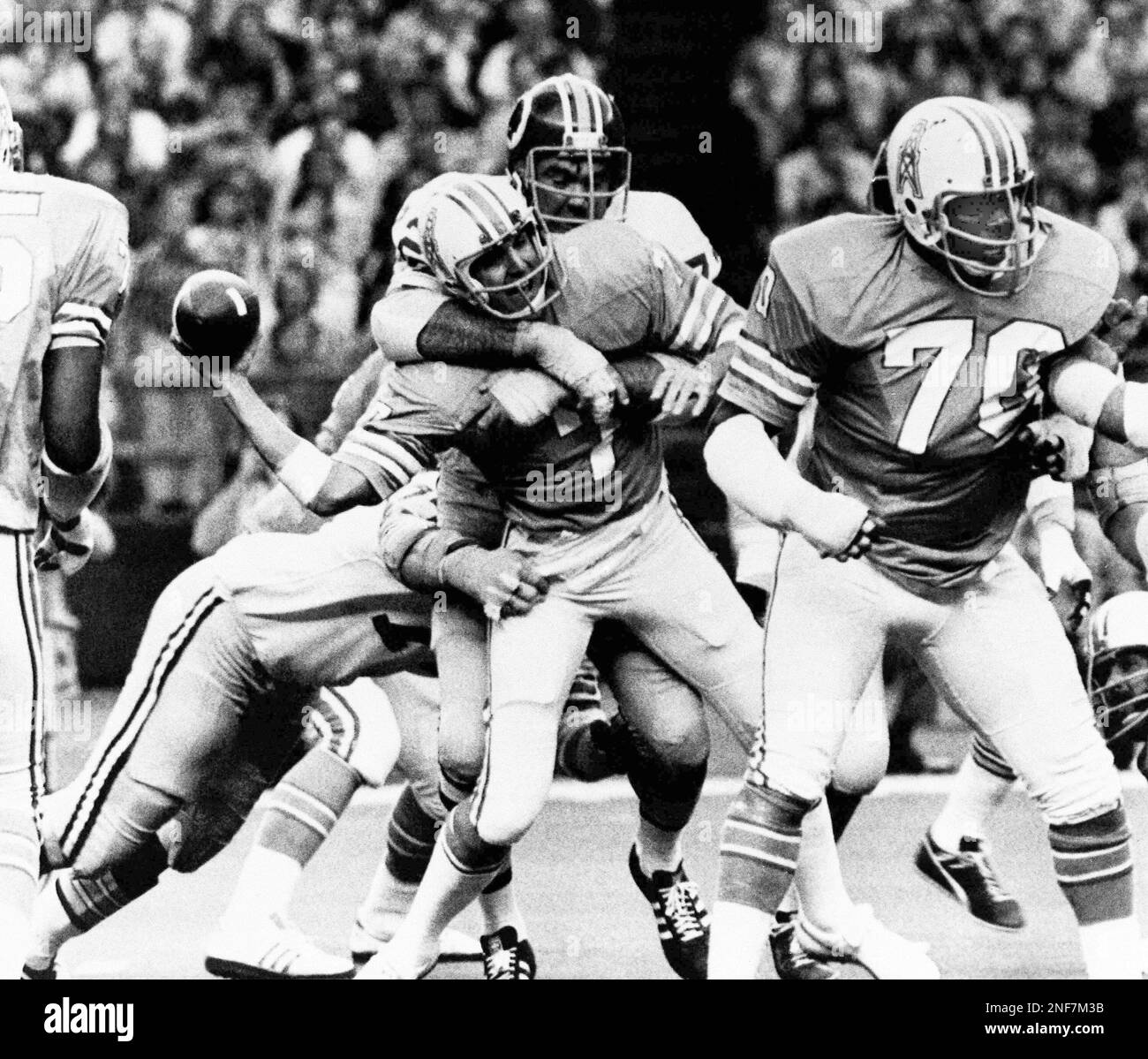 Houston Oiler quarterback Dan Pastorini (7) is sacked from the blind side  by Washington Redskin defensive tackle Diron Talbert (72) in the second  quarter of the game, Sunday, Oct. 19, 1975, Houston,