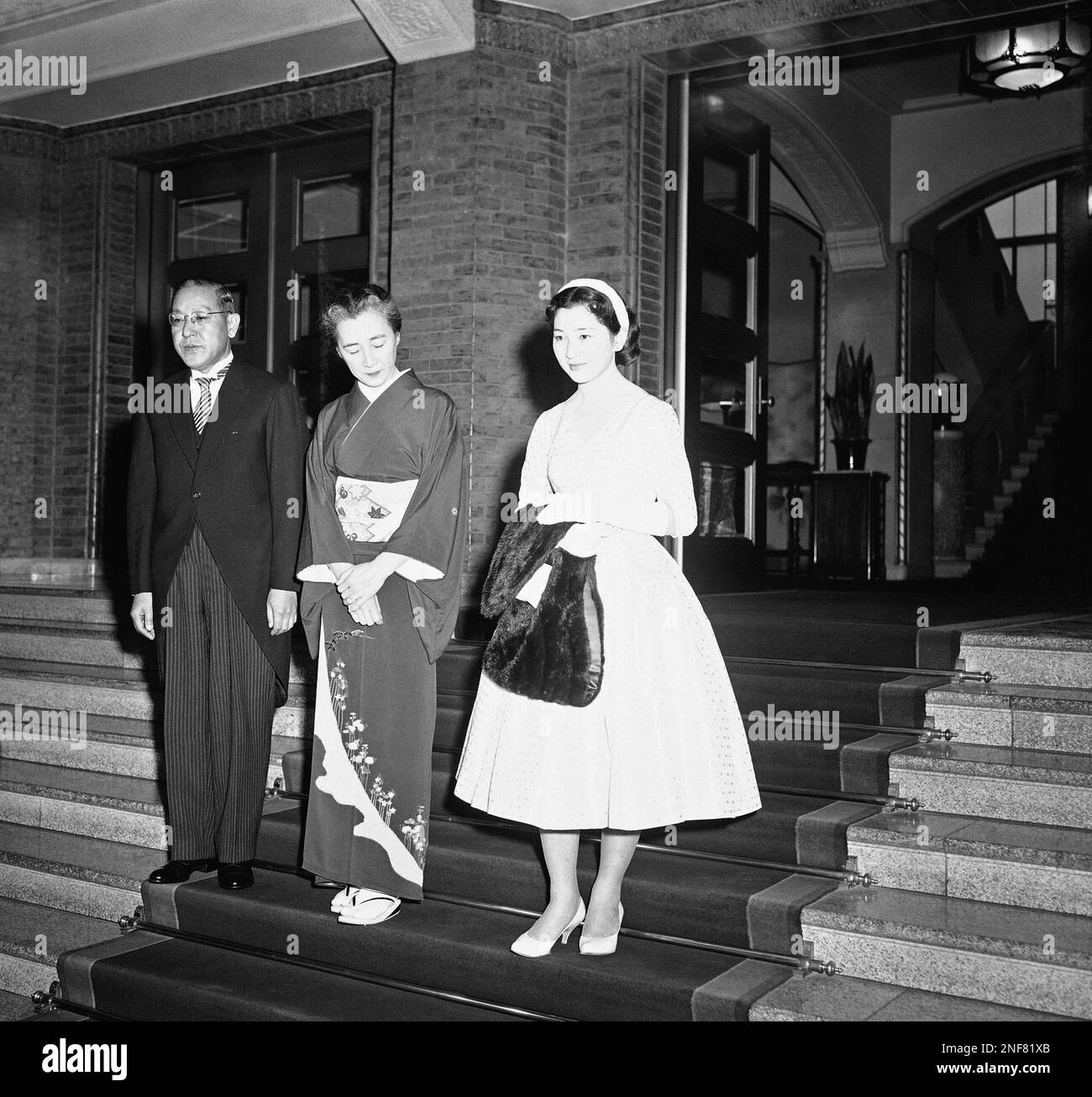 Japan's Crown Prince Akihito's bride-to-be, Michiko Shoda, is shown with  her parents after leaving the Japanese Imperial Palace in Tokyo, Nov. 27,  1958. Earlier Akihito won unprecedented permission to marry Michiko and