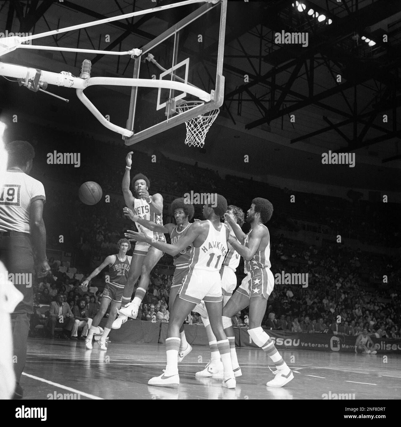 New York Nets and Phoenix Suns arms are outstretched for a loose ball