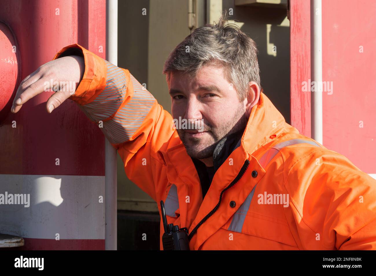 Portrait of a worker in orange work clothes Stock Photo