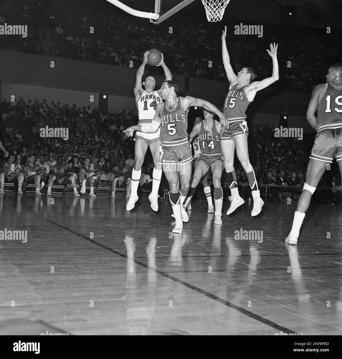 Lenny Wilkins of the St. Louis Hawks (14) pulls down an offensive