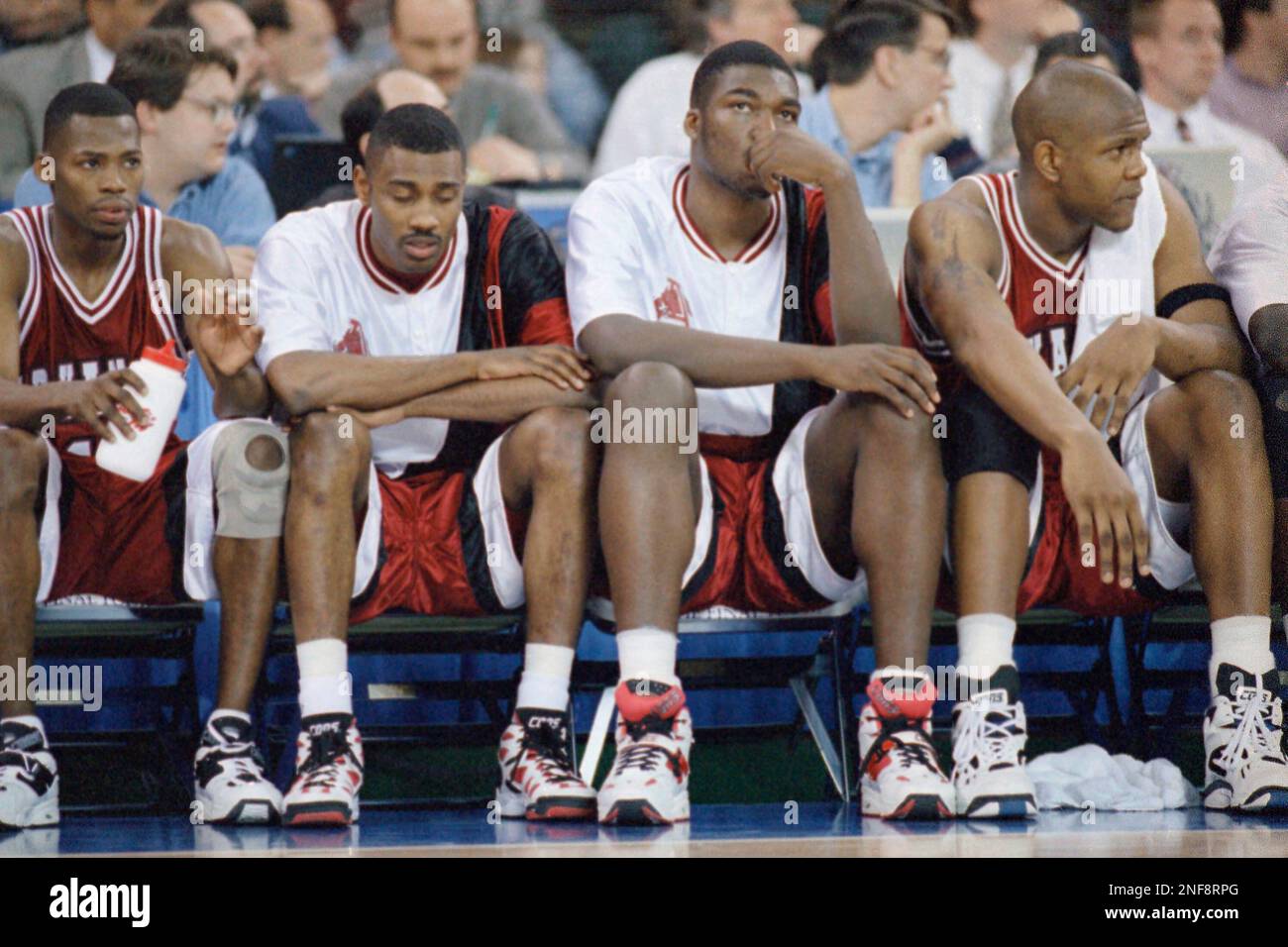Arkansas players Alex Dillard, left, Darnell Robinson, center, and Corliss Williamson sit on the bench in the closing minutes of their loss to UCLA at the NCAA Championship game at the Seattle Kingdome, April 3, 1995. UCLA won the title with a 89-78 victory. (AP Photo/Eric Draper) Stock Photo