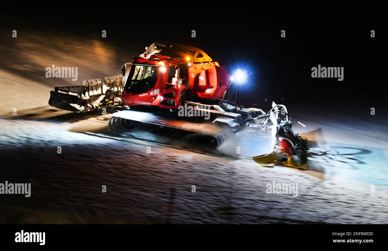 Oberwiesenthal, Germany. 15th Feb, 2023. A snow blower drives on the