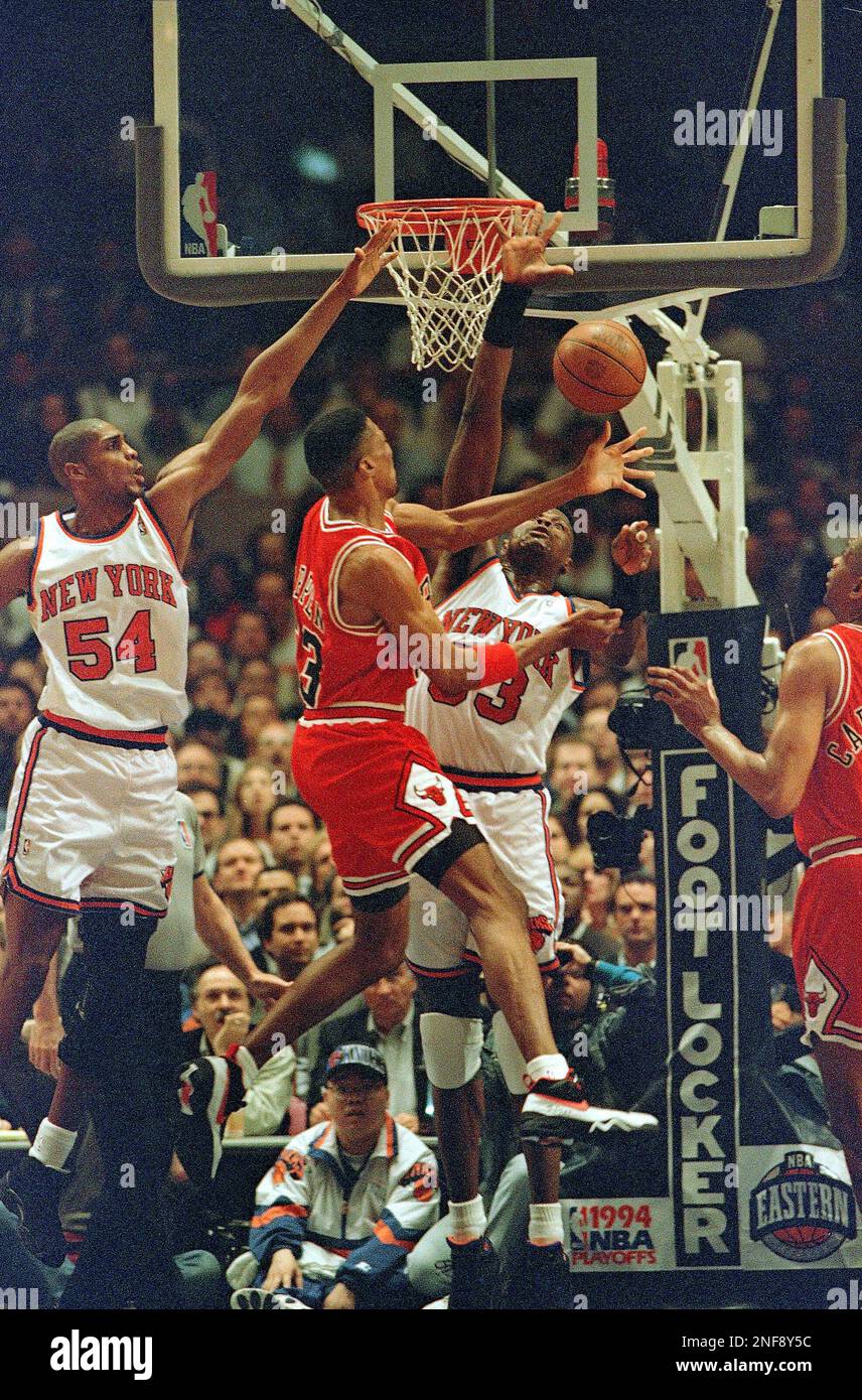 The New York Knicks' Charles Smith blocks the Chicago Bulls' Michael Jordan  as he goes to the hoop past John Starks, right, during the first quarter of  Game 6 in the Eastern