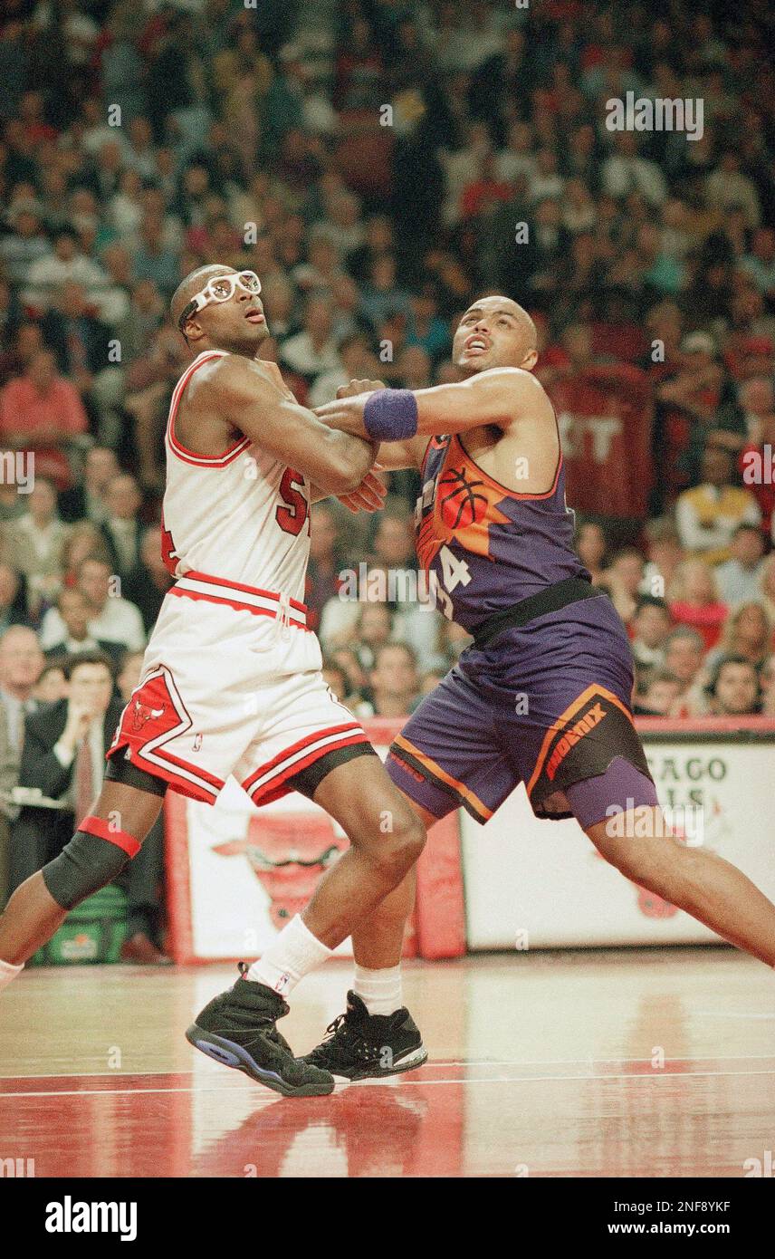 Chicago Bulls' Horace Grant, left, and Phoenix Suns' Charles Barkley push  for position during the fourth quarter in Game 4 of the NBA finals at  Chicago, June 17, 1993. The Bulls beat