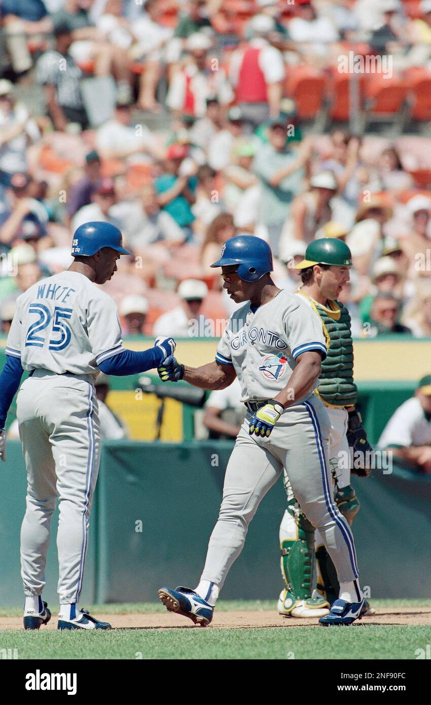 Toronto Blue Jays' Rickey Henderson, left, celebrates with teammate