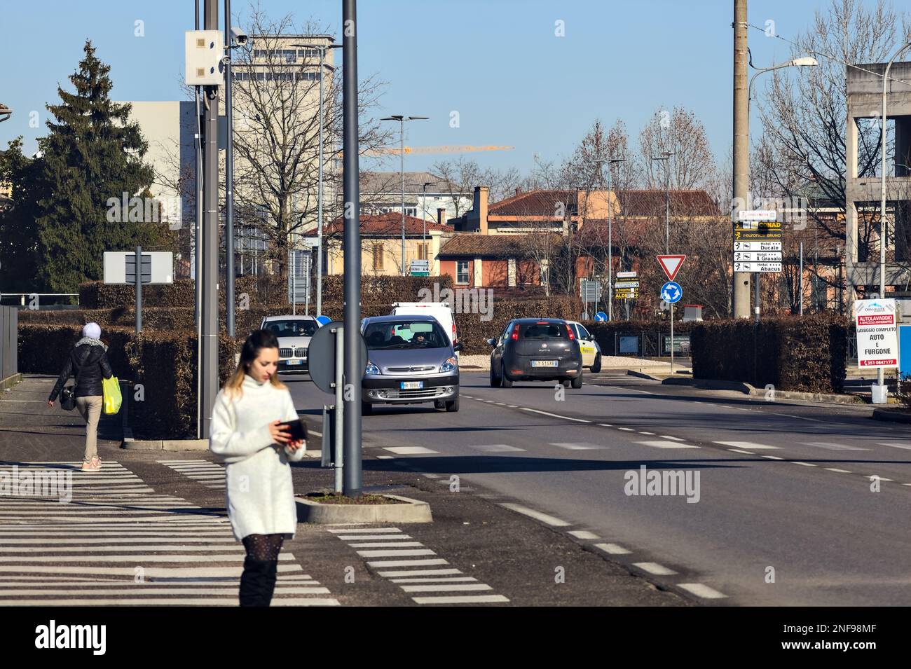 Country  road with gas stations and cars passing by on a sunny day Stock Photo