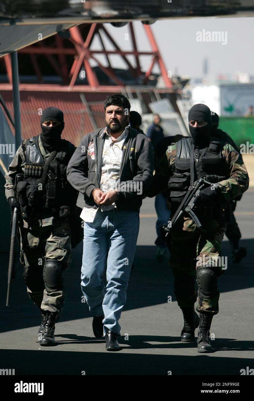 In this Jan. 21, 2008 file photo Mexican federal police officers escort