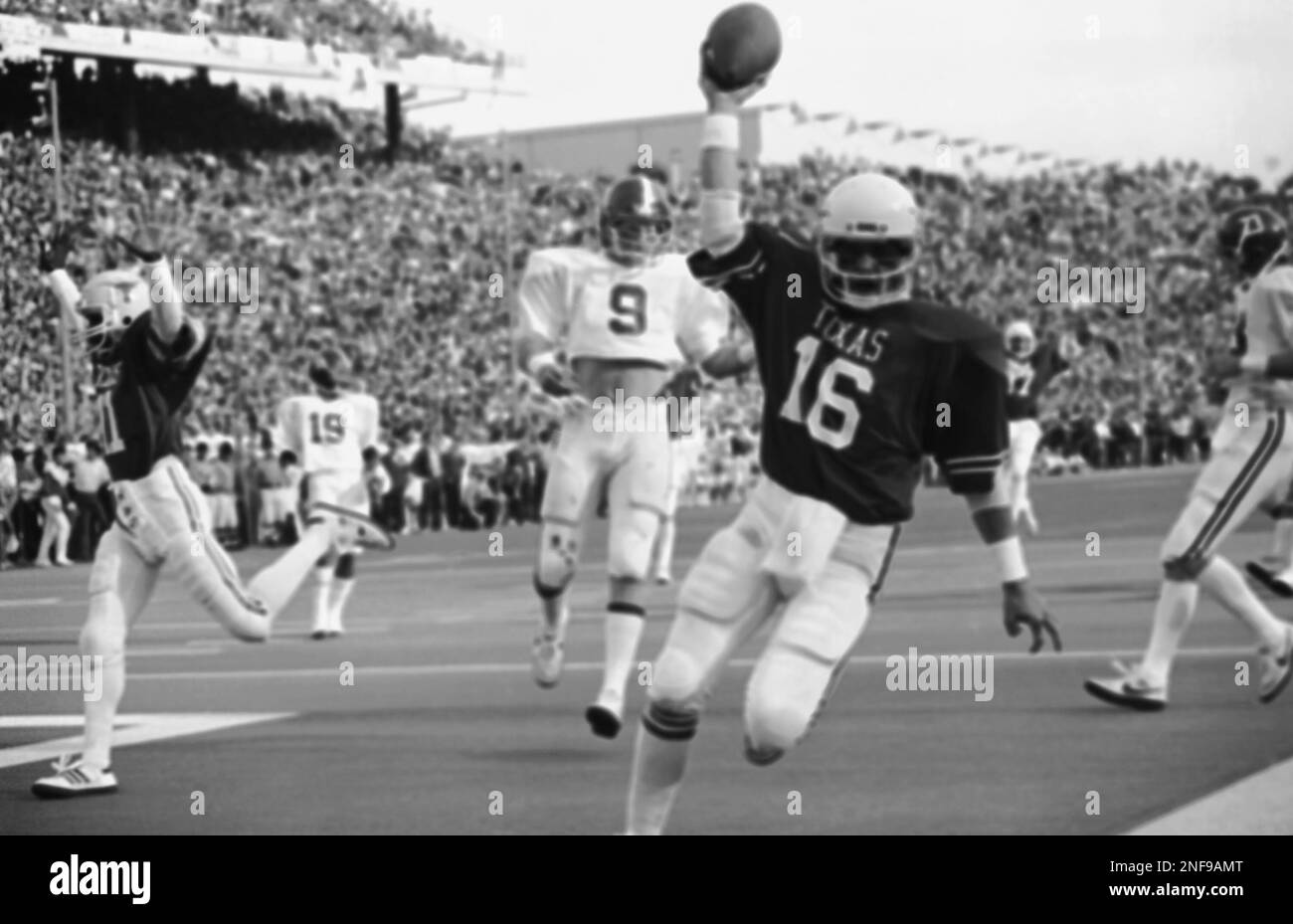Texas quarterback Robert Brewer (16) holds the ball aloft in the end zone  after scoring the Longhorns' first touchdown during fourth quarter action  with Alabama in the Cotton Bowl in Dallas, Jan.